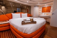 a bedroom on a luxury yacht with orange furniture