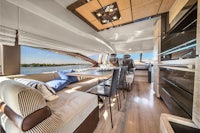 the interior of a luxury yacht with a dining table and chairs