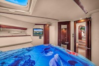 a boat with a bed and tv in it