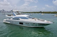 a silver motor yacht is floating in the water