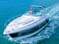 a man and woman are riding a motor boat in the ocean