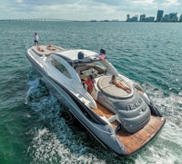 a motor yacht is traveling in the water with people on board