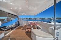 a yacht with a dining table and chairs on the deck