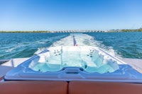 a hot tub on a boat with a bridge in the background
