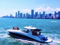 a group of people on a boat in the ocean near a city