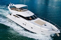 a white motor yacht is traveling in the water