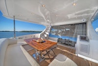 the interior of a yacht with a table and chairs