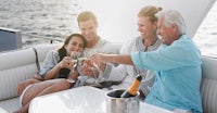 a group of people toasting champagne on a yacht